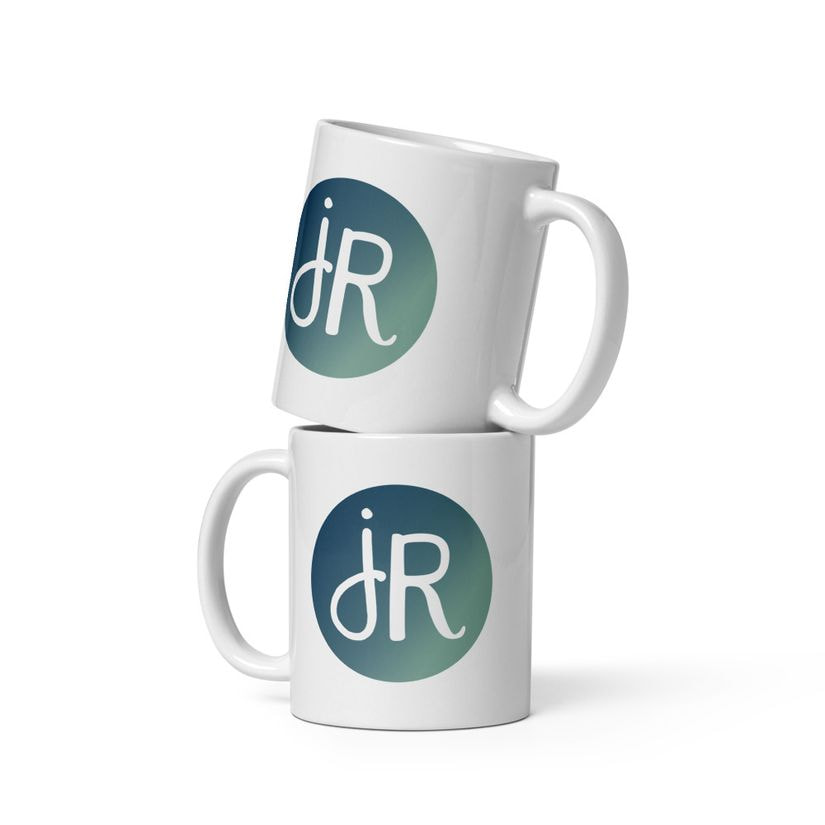 Two white glossy mugs carrying the jR monogram in a deep sea and sage circle